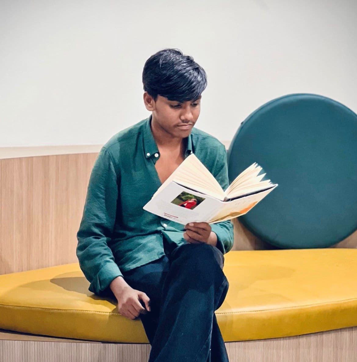 a man sitting to furniture and reading to book best freelance digital marketing expert in malappuram